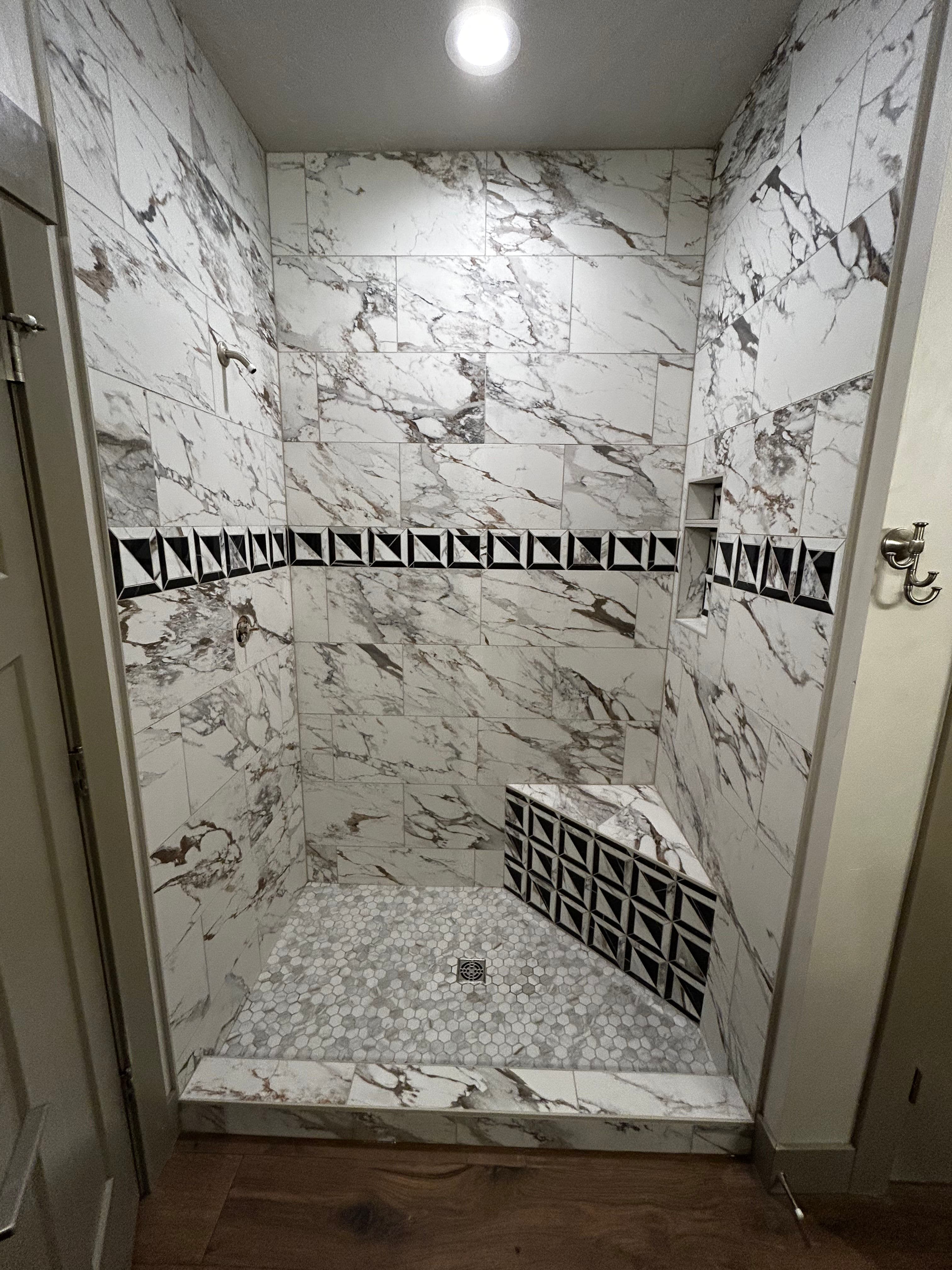 Project Bathroom Makeover with Marble-Patterned Tiles and Custom Features image